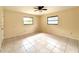 Cozy bedroom featuring tile floors, a ceiling fan, and a bright, airy ambiance at 12321 Alta Mira St, North Port, FL 34287