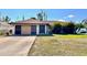 Charming single-story home with a well-maintained lawn and mature trees at 12321 Alta Mira St, North Port, FL 34287