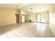 Open-concept living area with tile floors, adjacent to the kitchen and outdoor patio at 12321 Alta Mira St, North Port, FL 34287