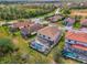 Aerial view of a beautiful home with a screened-in pool and well-manicured lawn in a desirable neighborhood at 12410 Cinqueterre Dr, Venice, FL 34293