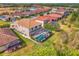 An elevated view of a home featuring a screened-in pool and well-maintained backyard landscaping at 12410 Cinqueterre Dr, Venice, FL 34293
