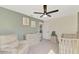 Comfortable Bedroom with a crib, changing table, and neutral decor at 12410 Cinqueterre Dr, Venice, FL 34293
