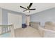 Comfortable Bedroom with a large closet, gray changing table, and glider chair at 12410 Cinqueterre Dr, Venice, FL 34293