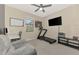 Bedroom featuring a treadmill, desk and television at 12410 Cinqueterre Dr, Venice, FL 34293