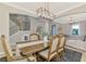 Dining area with a wooden table, upholstered chairs, and open access to other living spaces at 12410 Cinqueterre Dr, Venice, FL 34293