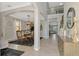Spacious home entryway featuring tile flooring, a staircase, and an adjacent dining area at 12410 Cinqueterre Dr, Venice, FL 34293