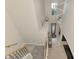 View from upstairs looking down to foyer with pendant lighting and decorative rug at 12410 Cinqueterre Dr, Venice, FL 34293