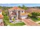The house boasts a tile roof, a brick driveway, a two-car garage and an American flag at 12410 Cinqueterre Dr, Venice, FL 34293