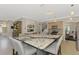Open kitchen showcasing a large island with bar seating, wooden cabinets, and modern appliances at 12410 Cinqueterre Dr, Venice, FL 34293