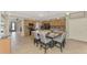 Large kitchen island with seating and a view of the appliances and cabinetry at 12410 Cinqueterre Dr, Venice, FL 34293