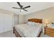 Main bedroom featuring a ceiling fan, closet, and modern decor at 12410 Cinqueterre Dr, Venice, FL 34293