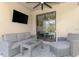 Relaxing screened lanai featuring wicker furniture, a ceiling fan, and backyard views at 12410 Cinqueterre Dr, Venice, FL 34293