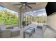 Screened in patio featuring gray wicker furniture, a ceiling fan, and views of the pool at 12410 Cinqueterre Dr, Venice, FL 34293