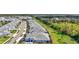 Aerial view of a neighborhood with tree lined streets, blue houses and a pond at 12505 Palatka Dr, Venice, FL 34293