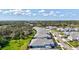 Aerial view of neighborhood featuring gray roofs, manicured lawns, and tree-lined streets at 12505 Palatka Dr, Venice, FL 34293