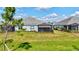 Well-maintained backyard featuring a screened lanai and lush green space at 12505 Palatka Dr, Venice, FL 34293