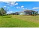 Well-maintained backyard with screened lanais, landscaped bushes and a beautiful lawn area at 12505 Palatka Dr, Venice, FL 34293