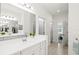 Bright bathroom featuring a double sink vanity and tiled floors at 12505 Palatka Dr, Venice, FL 34293