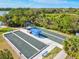 Overhead view of bocce ball courts with sun shelters, seating and palm trees at 12505 Palatka Dr, Venice, FL 34293