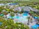 Aerial view of a community pool with palm trees, checkerboard patio and clubhouse at 12505 Palatka Dr, Venice, FL 34293