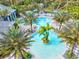 Community pool area with separate pools and covered seating surrounded by palm trees at 12505 Palatka Dr, Venice, FL 34293