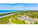Scenic aerial shot featuring recreational amenities like tennis and basketball courts, enhancing the active lifestyle of the community at 12505 Palatka Dr, Venice, FL 34293