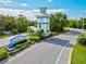 Welcoming community entrance sign with lush landscaping along a winding road at 12505 Palatka Dr, Venice, FL 34293