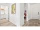 Bright hallway with modern flooring and access to bedrooms and laundry at 12505 Palatka Dr, Venice, FL 34293