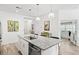 Bright kitchen features stainless steel appliances, a granite countertop island with seating, and stylish pendant lighting at 12505 Palatka Dr, Venice, FL 34293