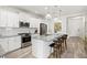 Modern kitchen with stainless steel appliances and a large center island at 12505 Palatka Dr, Venice, FL 34293