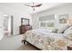 Bright main bedroom featuring a ceiling fan, blind-covered windows, and neutral paint at 12505 Palatka Dr, Venice, FL 34293