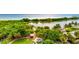 Overhead view of the community park, showcasing a large pond, lush trees, and playground amenities in a well-maintained setting at 12505 Palatka Dr, Venice, FL 34293