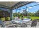 Relaxing screened patio overlooking the lush greenery provides a serene outdoor living space at 12505 Palatka Dr, Venice, FL 34293