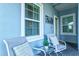 Cozy covered patio with comfortable chairs and decorative details at 12505 Palatka Dr, Venice, FL 34293