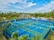 Multiple pickleball courts with players near parking and community buildings at 12505 Palatka Dr, Venice, FL 34293