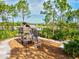 Wooden playground structure with mulch ground cover near a pond and mature trees at 12505 Palatka Dr, Venice, FL 34293