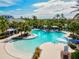 Inviting swimming pool area with lounge chairs, cabanas, and tropical landscaping at 12505 Palatka Dr, Venice, FL 34293