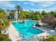 Large community swimming pool with lane lines, lounge chairs, and tropical landscaping at 12505 Palatka Dr, Venice, FL 34293