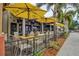 Outdoor dining area with umbrellas and tables at 12505 Palatka Dr, Venice, FL 34293