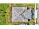 Aerial view of a well-maintained roof, landscaped yard and screened lanais at 12505 Palatka Dr, Venice, FL 34293