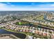Aerial view of a residential neighborhood with lakes, golf courses, and well-maintained homes at 1298 Highland Greens Dr, Venice, FL 34285