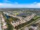 Wide aerial view of a sprawling residential community featuring scenic lakes and lush greenery at 1298 Highland Greens Dr, Venice, FL 34285