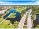 Overhead perspective of the golf course, featuring a picturesque water feature, a bridge and surrounding landscape at 1298 Highland Greens Dr, Venice, FL 34285