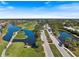 Aerial view of the community, showing lush landscaping, water features, and the golf course at 1298 Highland Greens Dr, Venice, FL 34285