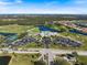 Overhead view of the community with lush greenery, lakes, and an inviting recreational center at 1298 Highland Greens Dr, Venice, FL 34285