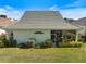 Aerial view of a home with a well-kept lawn and charming screened in patio at 1298 Highland Greens Dr, Venice, FL 34285