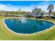 The Pelican Pointe Golf & Country Club entrance with a beautiful fountain, lush landscaping at 1298 Highland Greens Dr, Venice, FL 34285