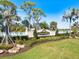 Beautifully landscaped entrance to Pelican Pointe Golf & Country Club with stone and greenery at 1298 Highland Greens Dr, Venice, FL 34285