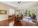 Dining room with hardwood floors and view of the screened-in lanai at 1298 Highland Greens Dr, Venice, FL 34285