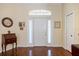 Charming foyer featuring natural light, hardwood floors, and space to welcome your guests at 1298 Highland Greens Dr, Venice, FL 34285